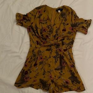 Super cute, like new romper. Zips in back, ties in front, has pockets.